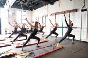 group of people wearing black workout clothes using resistance bands at BOARD30